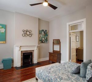 a living room with a bed and a fireplace at 414B Waldburg st · 2 Bedroom Oasis near Forsyth Park in Savannah