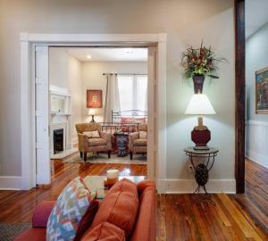 a living room with a couch and a table at 416A Waldburg st · Newly Renovated 1920's Historic District Apt in Savannah