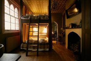 a bedroom with a bunk bed and a fireplace at Georgian House Hotel in London