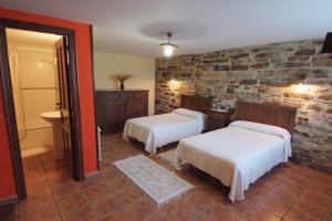 A bed or beds in a room at Apartamentos rurales Casa Do Cabo