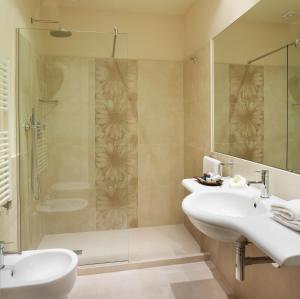 a bathroom with two sinks and a shower at Hotel Life in Rimini