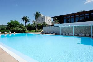 a large blue swimming pool in front of a building at Agriturismo Torre dei Preti in Peschici