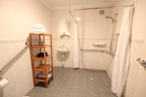 a bathroom with a shower and a sink at Port Vincent Motel & Apartments in Port Vincent