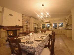 a dining room with a table and a fireplace at Villa with beautiful nature Lovely garden sauna in Karwieńskie Błoto Pierwsze