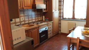 a kitchen with a sink and a stove top oven at Casa Vacanze Germano in Aosta +43 photos