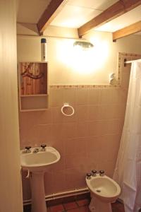 baño con lavabo, aseo y luz en La Casita de Melipal en San Carlos de Bariloche