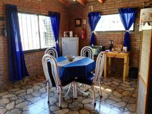 a dining room with a blue table and chairs at Monoambiente Amplio in La Falda