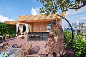 a patio with chairs and a bar on a roof at Adora Hotel in Ho Chi Minh City