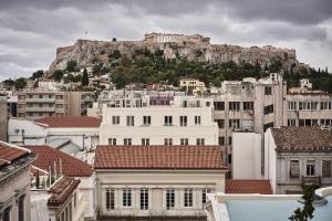 a group of buildings with a mountain in the background at Perianth Hotel, a Member of Design Hotels in Athens