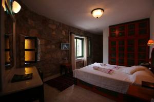 a bedroom with a bed and a table and a window at Villa Symbola in Oludeniz +55 photos