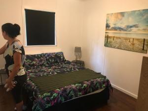A bed or beds in a room at Jungle River Home
