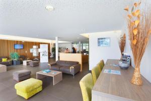 a living room with a couch and a table at Résidence Néméa Les Grands Rochers in Les Sables-d'Olonne