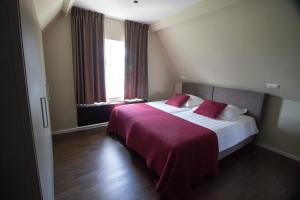 Ένα ή περισσότερα κρεβάτια σε δωμάτιο στο Villa Brion****