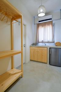 a kitchen with a sink and a stove top oven at Rooster Guesthouse Rooms in Kipri