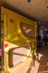 a large yellow appliance sitting on the floor in a room at Wuwei Qiyou Space Capsule Hostel in Wuwei