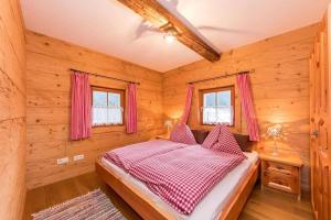 1 dormitorio con 1 cama en una cabaña de madera en Bauernhütte Niedermaisgut, en Eben im Pongau