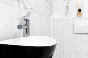 a black and white bathroom with a sink at Original twin Studio Delft City Central Station 30B in Delft