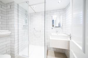 a white bathroom with a sink and a shower at Toby Carvery Hull by Innkeeper's Collection in Hull