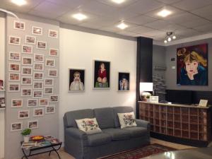 a waiting room with a couch and pictures on the wall at Hotel Genziana in Genoa