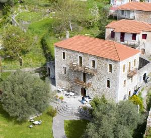 an aerial view of a large stone building with a yard at Theoni's House in Dhímitra