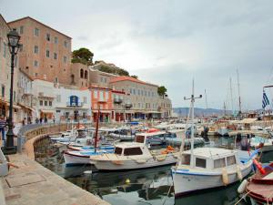 a bunch of boats are docked in a harbor at Glaros Guesthouse in Hydra