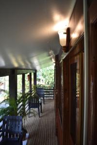 a porch with chairs and tables on a house at Club Palolem Resort in Palolem