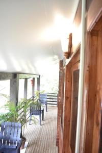 a balcony with blue chairs and benches on a building at Club Palolem Resort in Palolem