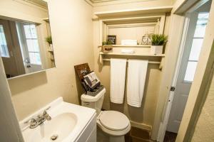 a bathroom with a sink and a toilet and a mirror at Hays #B Near Downtown Guest Studio in San Antonio +11 photos