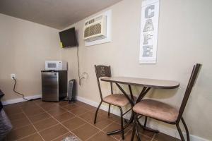 a room with a table and two chairs and a refrigerator at Hays #B Near Downtown Guest Studio in San Antonio