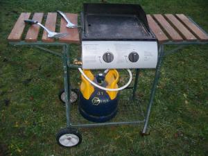a grill sitting on a picnic table next to a table at chez nicole in Giez