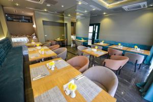 a dining room with wooden tables and chairs at River View Hotel Tbilisi in Tbilisi City