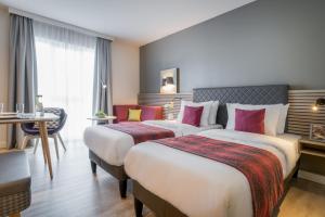 Postel nebo postele na pokoji v ubytování Citadines Arnulfpark Munich