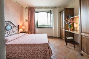 Postel nebo postele na pokoji v ubytování B&B Ponte a Nappo San Gimignano