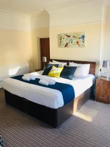 a large bed in a hotel room at The New Brighton Hotel in New Brighton