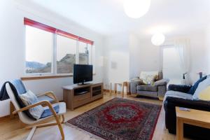 a living room with a tv and a couch at Skye View in Glenelg