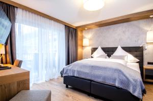 Postel nebo postele na pokoji v ubytování Hotel Garni Funtana