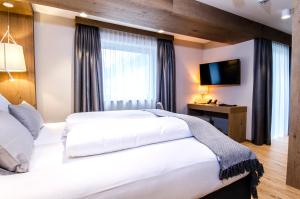 Postel nebo postele na pokoji v ubytování Hotel Garni Funtana
