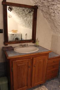 a bathroom vanity with a sink and a mirror at Fiocco di Neve in Montjovet