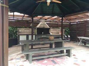 an outdoor picnic table with an outdoor fireplace at Litsa Haus Estate Residences & Suites - Adults Only & Kids 12 Plus- in Asprovalta