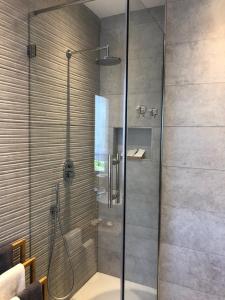 a shower with a glass door in a bathroom at Home Sweet Home in Treviso
