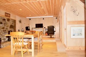 a dining room with a wooden table and chairs at The Boathouse in Glencoe