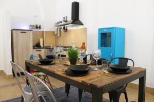 a wooden table with black bowls and wine glasses on it at Exclusive Central Apartment 48 in Rome
