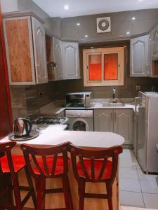 a kitchen with a table and two chairs in it at Elaf Suites Al Hamra in Jeddah