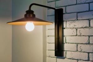 a light hanging on a brick wall next to a wall at Center Chic Hotel - an Atlas Boutique Hotel in Tel Aviv