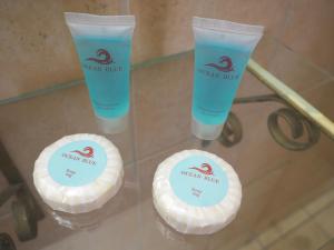 a glass table with two bottles of cream at Hotel Maragato in San José +125 photos