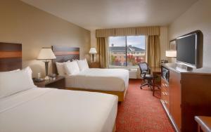 a hotel room with two beds and a flat screen tv at Holiday Inn Express Orem-North Provo, an IHG Hotel in Orem