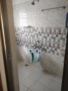 a bathroom with a toilet and a sink at Tulip Suites in Coimbatore