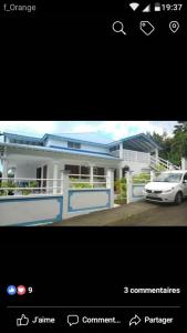 a picture of a house with a car in front of it at Résidence BLEUE DE MER in Deshaies