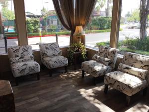a room with three chairs and a table and a window at Laguna Hills Lodge-Irvine Spectrum in Laguna Hills
