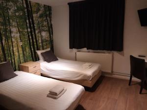 Ένα ή περισσότερα κρεβάτια σε δωμάτιο στο Hotel Velsen